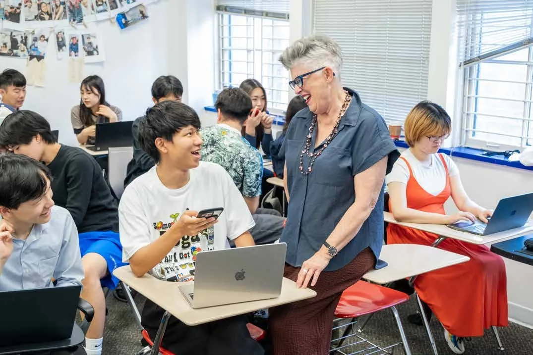 Students interacting with their teacher in a classroom